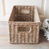seagrass storage tote with metal frame and cut out handles